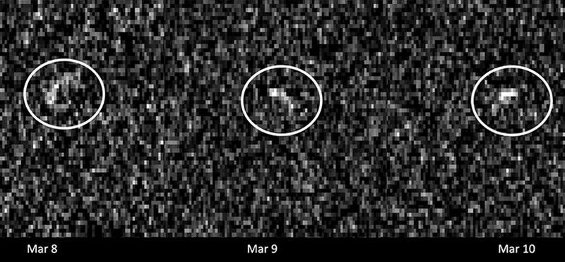 A grainy image with a distant asteroid circled